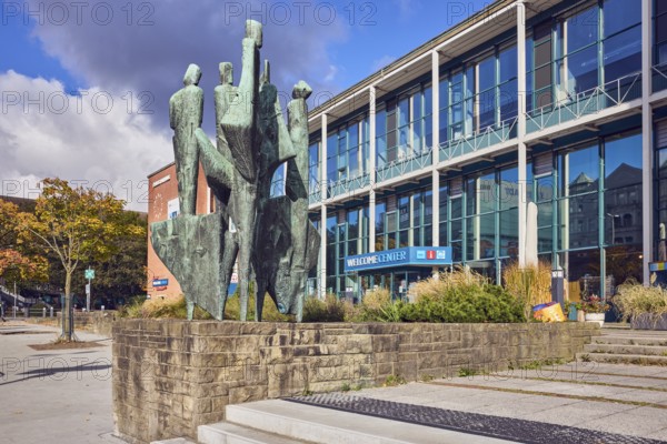 Bronze sculpture The Five Continents, sculptor Bernhard Heiliger, sandstone pedestal, welcome center, town hall, modern architecture, building, glass façade, staircase, city trees, flower bed, blue sky, cumulus clouds, Stresemannplatz, Kiel, state capital, district-free city, Schleswig-Holstein, Germany