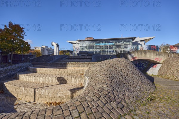 Wunderino Arena multi-purpose hall or former Baltic Sea Hall, well complex, building material brick, cobblestones and paving stones, sidewalk made of paving stones and cobblestones, barrier bollard, lantern, pedestrian zone, blue sky, cloudless, splash, Europaplatz, Kiel, state capital, district-free city, Schleswig-Holstein, Germany