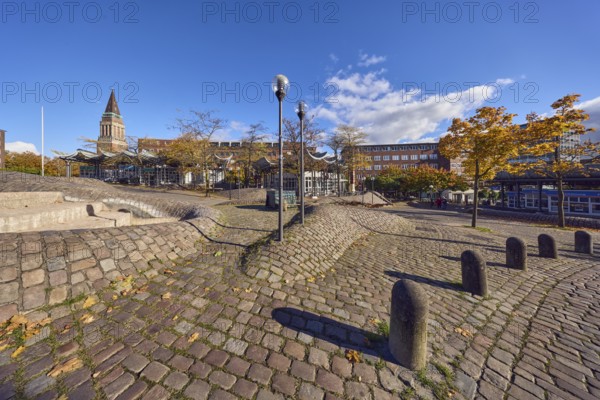 Pedestrian zone, lantern, barrier bollard, cobblestone walkway, general architecture, brick buildings, brick architecture, town hall tower, fountain, trees, autumn leaves, blue sky, cumulus clouds, Europaplatz, Kiel, state capital, district-free city, Schleswig-Holstein, Germany