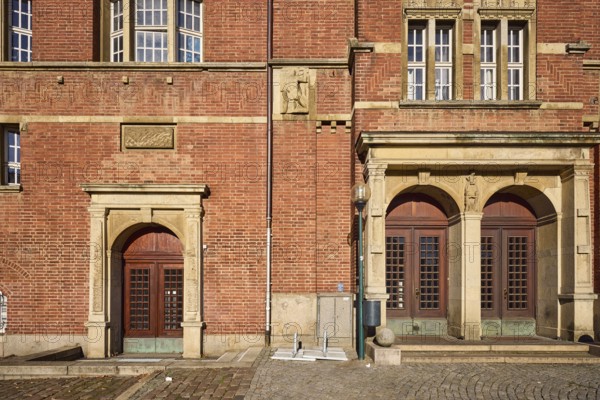 Opera house, architect Christian Heinrich Seeling, art nouveau style, brick architecture, historic brick buildings, entrance, façade with windows and doors, composite wall, sandstone and brick building material, paving stone walkway, sunny, town hall square, Kiel, state capital, district-free city, Schleswig-Holstein, Germany