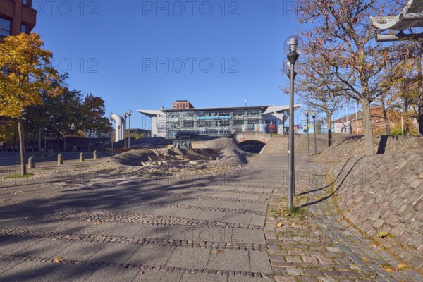 Pedestrian zone, lantern, barrier bollard, multi-purpose hall Wunderino Arena or former Baltic Sea Hall, footpath made of paving stones and cobblestones, trees, autumn leaves, blue sky, cloudless, squirt, Europaplatz, Kiel, state capital, district-free city, Schleswig-Holstein, Germany