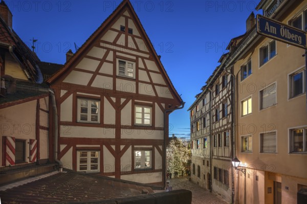 Historic half-timbered houses with a view of the Christmassy decorated Tiergärtnertorplatz in the evening, Ölberg, Nuremberg, Middle Franconia, Bavaria, Germany