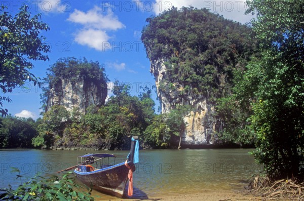 Longtail boat on the banks of the tidal river near Krabbi, two years in front of the tsunami, Thailand, December 2002, vintage, retro, old, historic