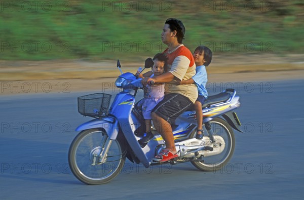 Father with his two children on a moped, Krabi, Thailand, December 2002, vintage, retro, old, historic