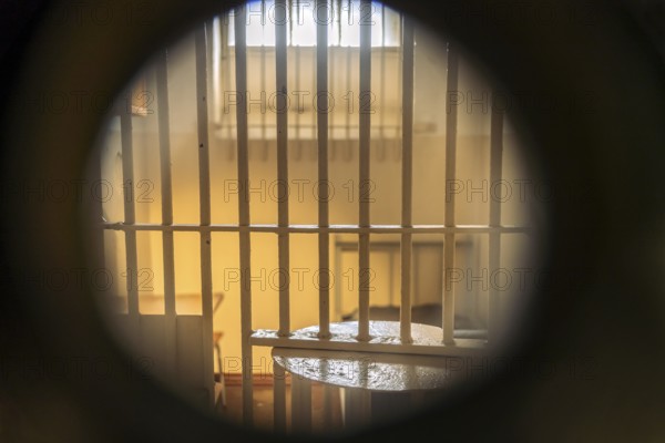 View through a keyhole into a cell in the former Stasi prison Bautzen II, now a memorial in Bautzen, Upper Lusatia, Saxony, Germany