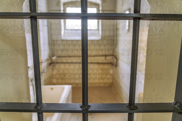 View through the grid into a bathroom in the former Stasi prison Bautzen II, now a memorial in Bautzen, Upper Lusatia, Saxony, Germany