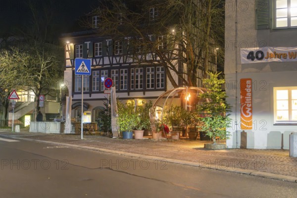An illuminated street with a half-timbered house and a decorative dome next to plants under a night sky, Gastro Bubbles, Sindelfingen, Germany