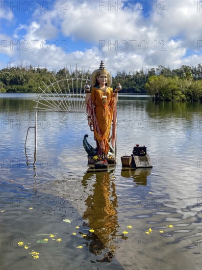 Hindu god figure figure sculpture of goddess deity Parvati woman woman woman woman Shakti of Lord Shiva Hindu mother goddess mother of Ganesha standing in sacred Hindu lake Ganga Talao at religious site largest Hindu shrine for religion Hinduism outside India for believers Hindu Hindus, in the background Sacred Lake Ganga Talao crater lake in crater of extinct volcano, Grand Basin, Le Petrin, Mauritius