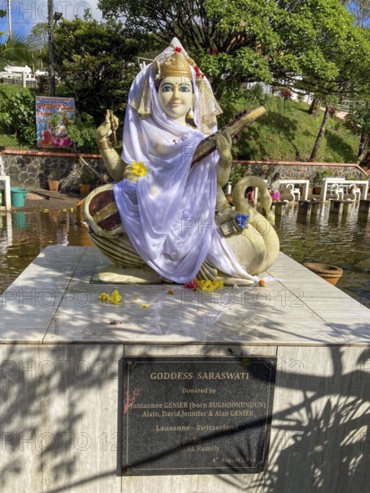 Statue sculpture of Hindu deity Saraswati stands in crater lake in crater of extinct volcano sacred Hindu lake Ganga Talao at religious site largest Hindu shrine for religion Hinduism outside India for believers Hindi Hindus, Grand Bassin, Le Pétrin, Mauritius
