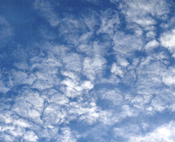Medium-high white clouds of Altocumulus fractus in blue sky, international