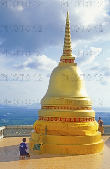 People, man praying, chedi in Wat Tam Sua monastery, which is partly on the top of a mountain, Krabi, Thailand, December 2002, vintage, retro, old, historic