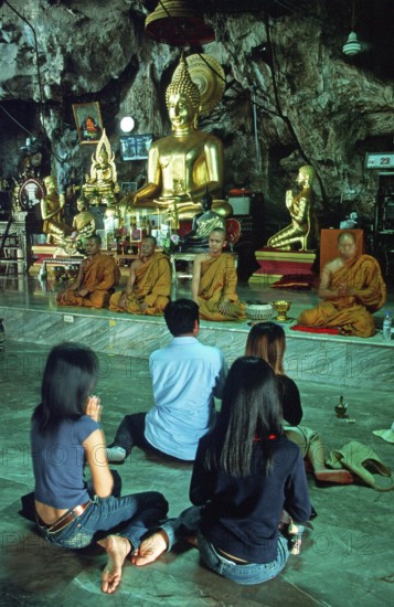Buddha statue, monks and believers praying, Wat Tam Sua monastery near Krabi, Thailand, December 2002, vintage, retro, old, historic