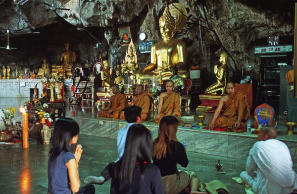Buddha statue, monks and believers praying, Wat Tam Sua monastery near Krabi, Thailand, December 2002, vintage, retro, old, historic