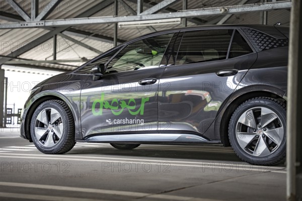 Black car sharing car with LEASER branding on side view in parking garage, Cupra electric car, e-car sharing, Calw, Germany
