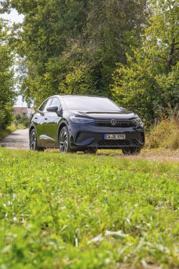 Black SUV on a green forest path surrounded by nature and trees, Cupra electric car, e-car sharing, Calw, Germany
