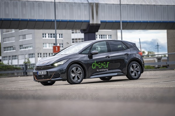 A modern Cupra stands in a parking lot in an urban area under a cloudy sky, electric car Cupra, e-car sharing, Calw, Germany