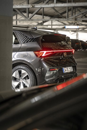 Rear view of a modern black car with distinctive LED rear lights in garage, Cupra electric car, e-car sharing, Calw, Germany
