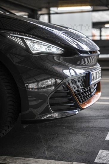 Close-up of a modern black car in underground garage with sporty design, Cupra electric car, e-car sharing, Calw, Germany