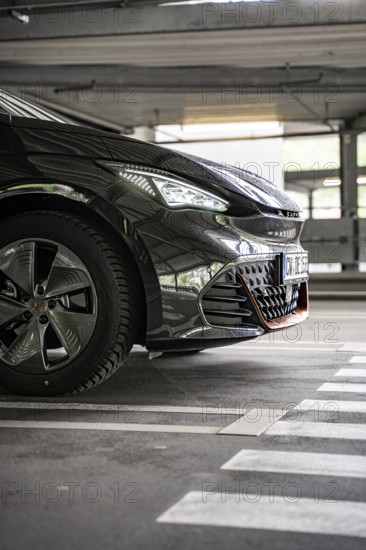 Close up of a black car in an urban parking lot from the front, electric car Cupra, e-car sharing, Calw, Germany