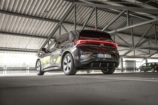 Modern black car in an urban parking garage from the rear view, Cupra electric car, e-car sharing, Calw, Germany