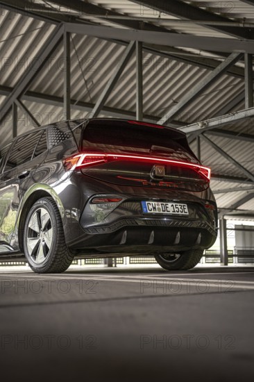 Back view of a black car under a covered parking lot, electric car Cupra, e-car sharing, Calw, Germany