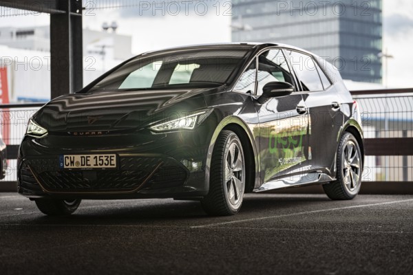 Black car sharing car in front of glass architecture, modern design and urban style, Cupra electric car, e-car sharing, Calw, Germany