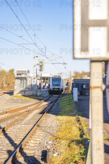 Train arrives at station, bright daylight, modern track system, Weil der Stadt station, Germany