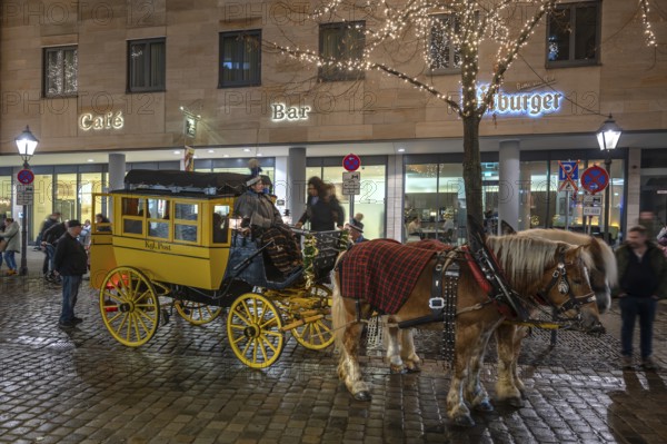 Horse-drawn carriage ride in a historic stagecoach at Chriskindlesmarkt, Hauptmarkt, Nuremberg, Middle Franconia, Bavaria, Germany