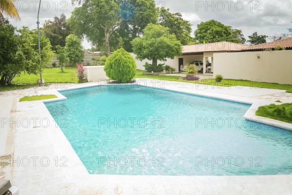Beautiful crystal clear home pool. A crystal clear home swimming pool on a sunny day, Concept of home swimming pool designs