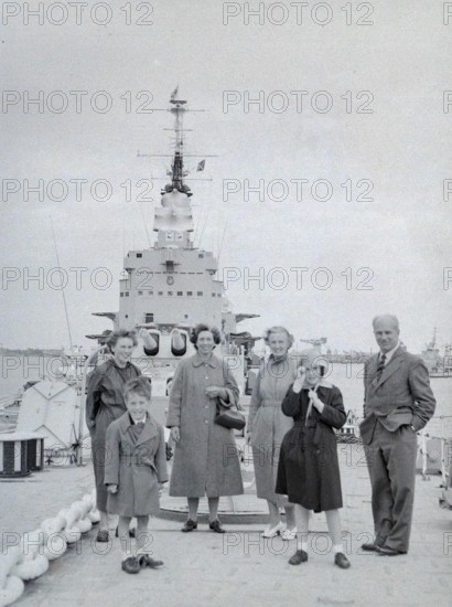 Family group of people on Royal Navy HMS Vanguard battleship, Devonport, Plymouth, Devon, England, UK c 1956