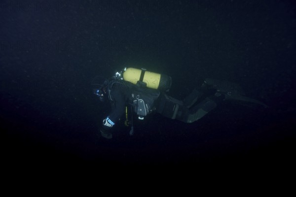 Divers at night in Lake Walen. Tauchplatz Känzeli, Mols, Canton of St. Gallen, Switzerland