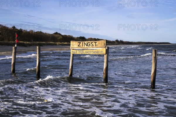 Wooden poles in the sea with wooden sign Zingst Half Island Half Paradise, Zingst, Fischland-Darß-Zingst, Western Pomerania Lagoon Area National Park, Mecklenburg-Western Pomerania, Germany