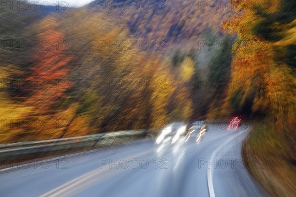 Car, light trails, rain-wet road, curvy country road, autumn leaves, Indian summer, smudge effect, blur, Kancamagus Highway, White Mountain, New Hampshire, New England, USA