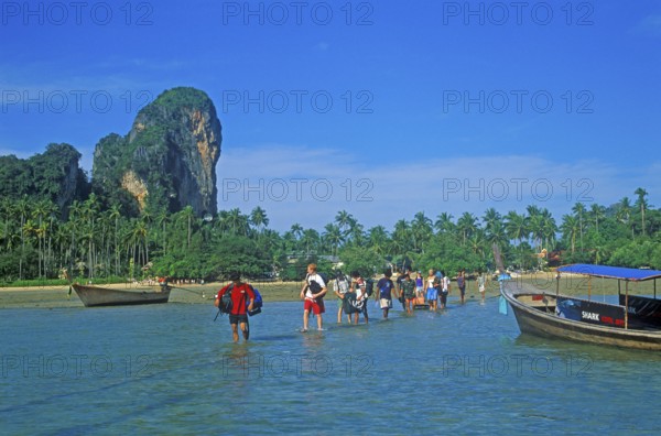 Tourists wade to their boat taxi that brings them back to Krabi, two years in front of the tsunami, Railay East, Krabi, Thailand, December 2002, vintage, retro, old, historic