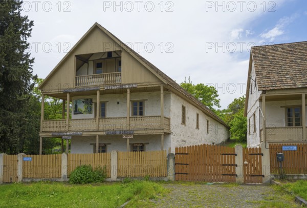 Traditional house with wooden balcony and fence in a rural setting with cloudy skies, village founded by Caucasian Germans, Asureti, Asureti, Elizabeth Valley, Lower Kartli region, Georgia