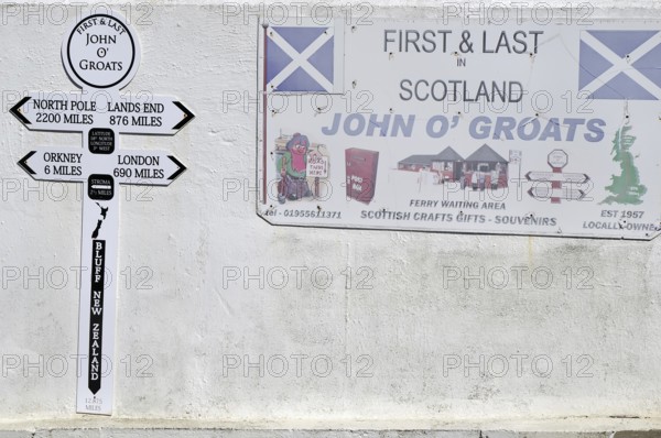 Wall panel with signs and distances at John O'Groats in Scotland, Great Britain