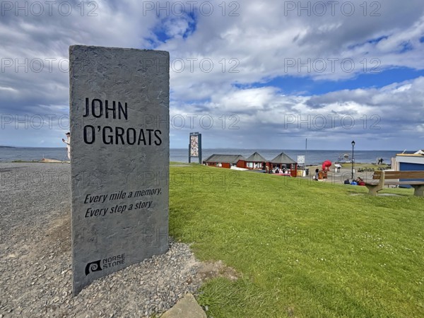 Stone with quote at sea view and green lawn in John O'Groats, Scotland, Great Britain