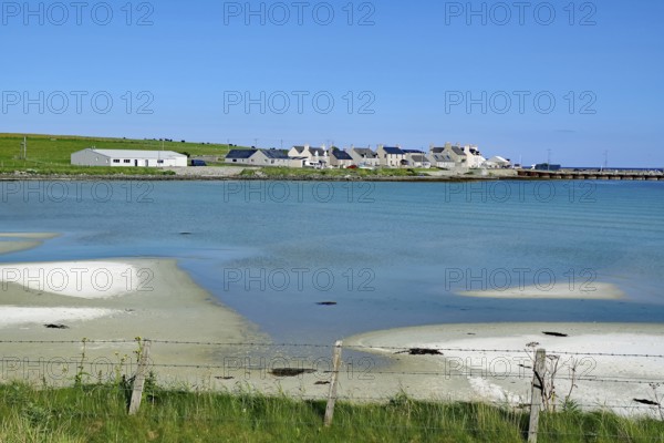 Small village on a peaceful coast with blue water and clear skies, Pierowall, Orkney Islands, Ornkeys, Scotland, Great Britain
