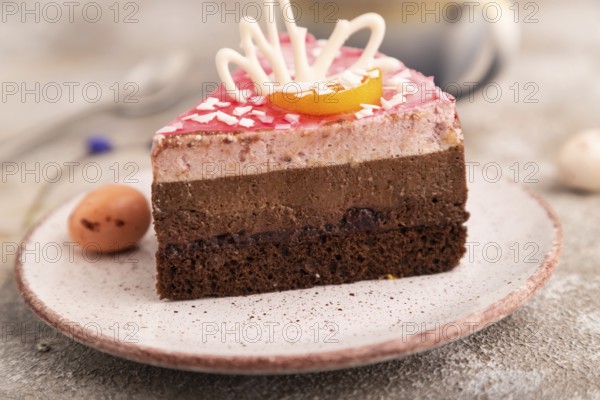 Chocolate cake on brown concrete background, cup of coffee, side view, close up, selective focus