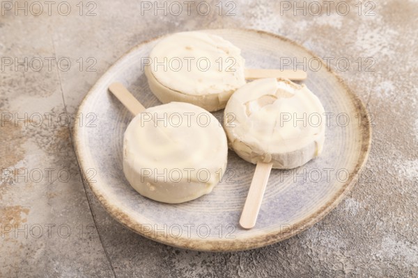 ?hocolate Ice cream in white glaze, on brown concrete background, side view, close up, minimalism
