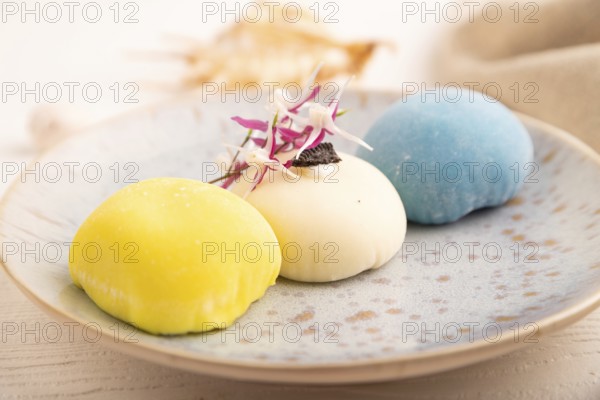 Japanese Mochi Cakes on white wooden background and linen textile, side view, close up, selective focus