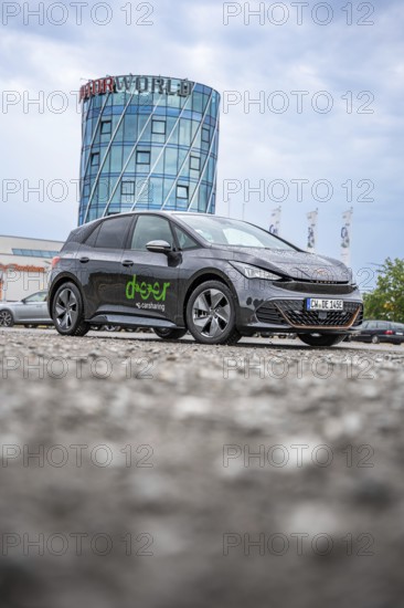 Car in front of a modern tower in a parking lot, deer e-car sharing, Cupra electric car, Böblingen, Germany