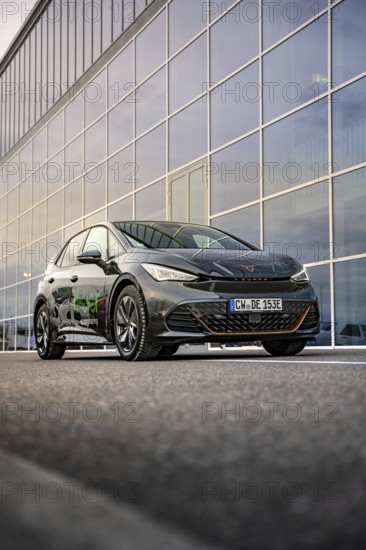 Car in front of a large glass façade of a modern office building, Deer E-Car Sharing, Cupra electric car, Böblingen, Germany
