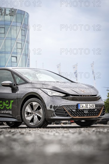 A rain-wet car in front of a modern office building, Deer E-Car Sharing, Cupra electric car, Böblingen, Germany