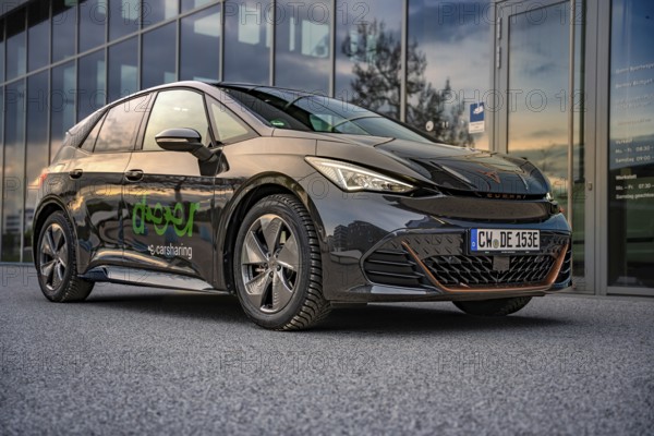 Car at dusk with reflection in a parking lot, Deer E-Car Sharing, Cupra electric car, Böblingen, Germany