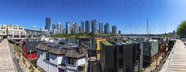 Panoramic view of colorful floating homes in false creek with modern and historical buildings of vancouver in the background, british columbia, canada