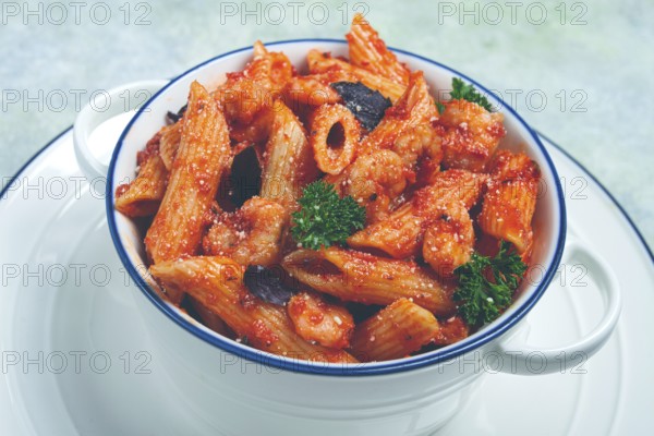 Penne pasta, with shrimp in tomato sauce, close-up, no people