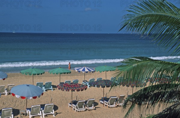 Palm tree, umbrellas and sun loungers at Karon Beach, two years in front of the tsunami, Ko Phuket, Thailand, December 2002, vintage, retro, old, historic
