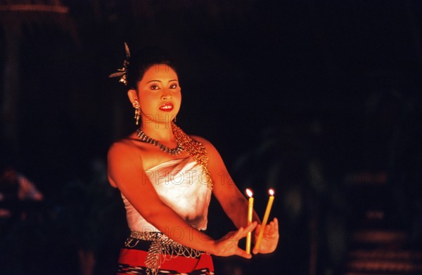 Young woman performing a traditional candle dance, Ko Phuket, Thailand, December 2002, vintage, retro, old, historic