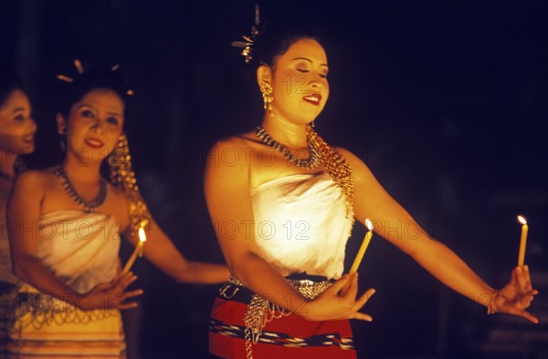 Young woman perform a traditional candle dance, Ko Phuket, Thailand, December 2002, vintage, retro, old, historic